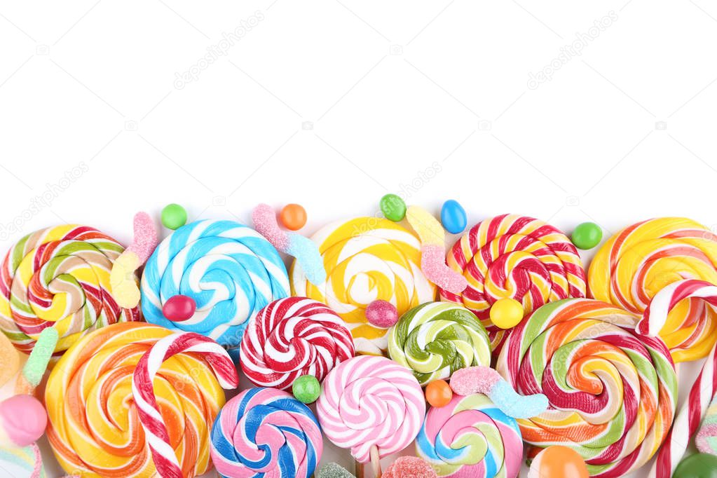 Sweet candies and lollipops on white background