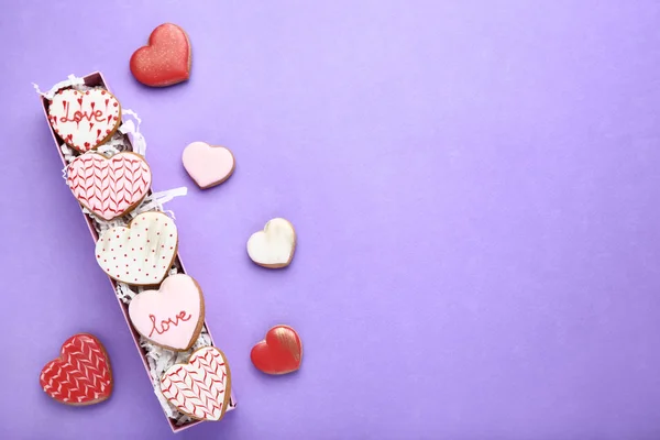 Valentine day heart shaped cookies in box on purple background