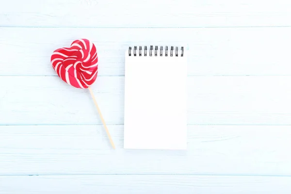 Piruleta Forma Corazón Con Cuaderno Mesa Madera —  Fotos de Stock