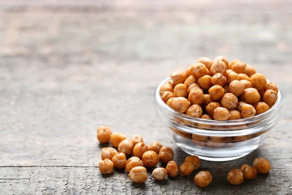 Roasted chickpeas in bowl on grey wooden table