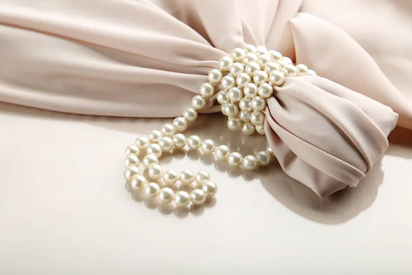 Pearl necklace with beige satin fabric