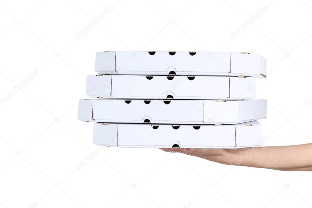 Female hand holding pizza boxes on white background