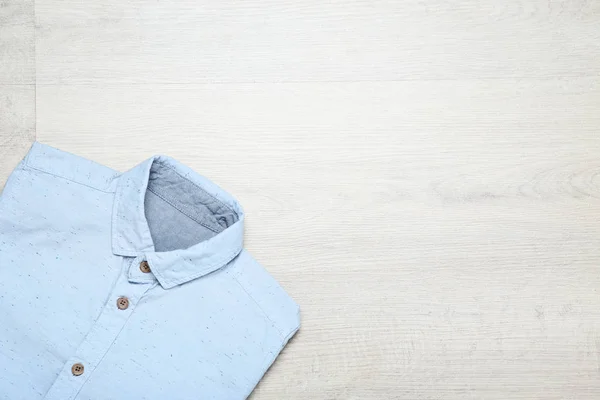 Folded shirt on wooden table