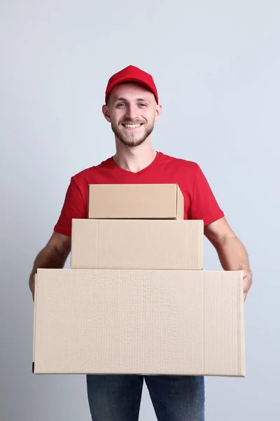 Delivery Man Cardboard Boxes Grey Background — Stock Photo, Image