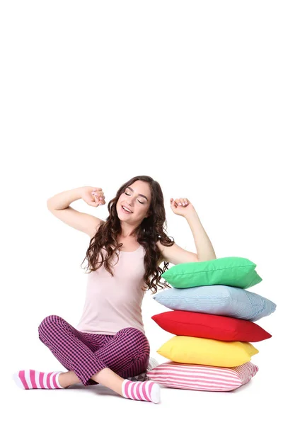 Bocejo Menina Com Almofadas Coloridas Sentado Fundo Branco — Fotografia de Stock