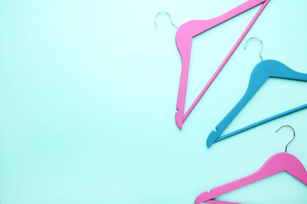 Colorful hangers on blue background