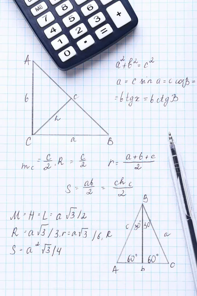 Exercise book with maths formulas and calculator — Stock Photo, Image