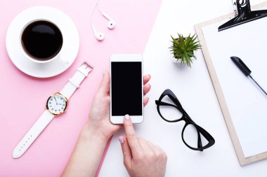 Kadın elinde fincan kahve, gözlük ve bilek ile Smartphone