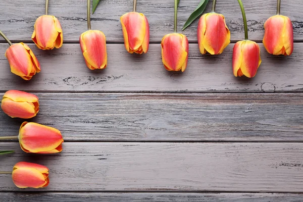 Bouquet of tulips on wooden table — Stock Photo, Image