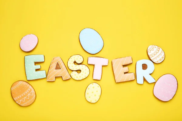 Word Easter by gingerbread cookies on yellow background — Stock Photo, Image