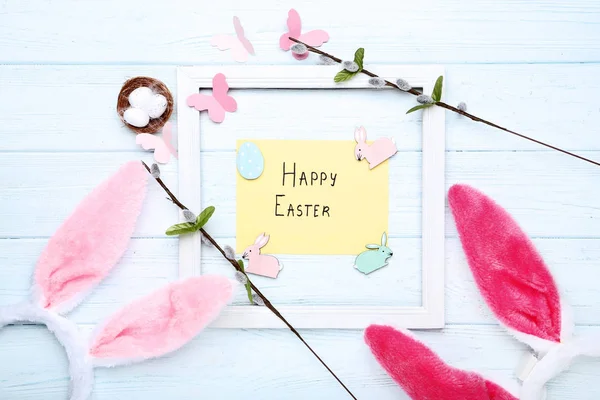 Orejas de conejo con huevos pequeños, ramas de árbol y texto Feliz Pascua — Foto de Stock
