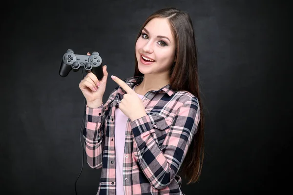 Hermosa chica con joystick sobre fondo negro —  Fotos de Stock