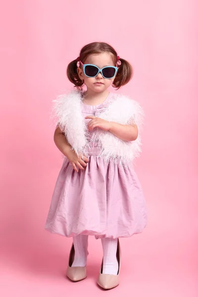 Beautiful little girl in fashion clothes on pink background — Stock Photo, Image