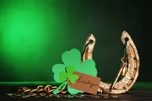 St.Patrick's Day. Golden horseshoe with clover leafs and coins — Stock Photo, Image