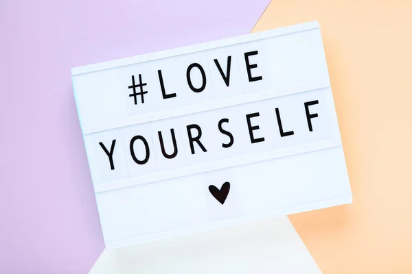 Lightbox with words Love Yourself on colorful background