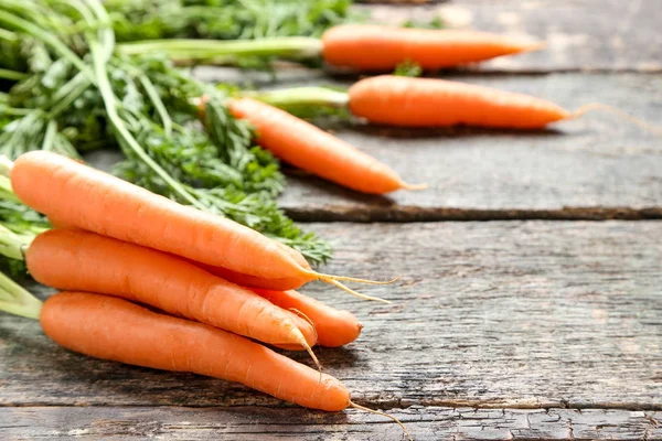 Fresh carrot on grey wooden table — Stock Photo, Image
