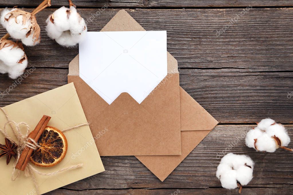 Paper envelopes with cinnamon sticks, dry orange fruit and cotto