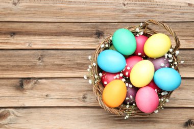 Paskalya yumurtaları ile ahşap masaya gypsophila çiçek sepeti