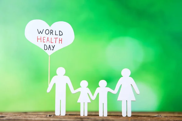 Εικόνα κείμενο παγκόσμια ημέρα υγείας με την οικογένεια σε πράσινο φόντο — Φωτογραφία Αρχείου
