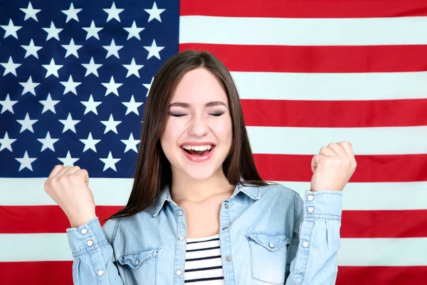 Young beautiful girl on American flag background — Stock Photo, Image