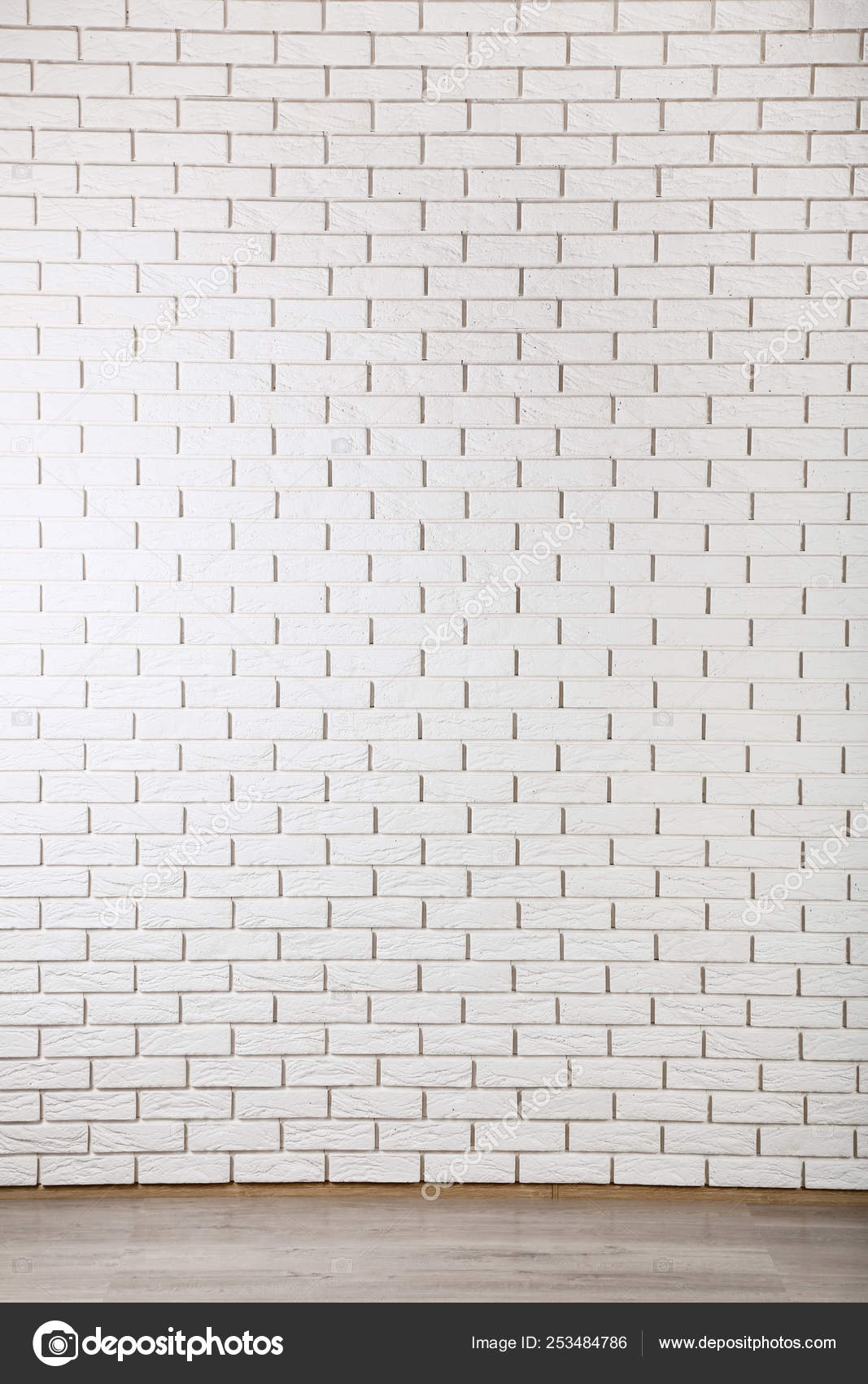 White Brick Wall And Timber Laminate Flooring Stock Photo