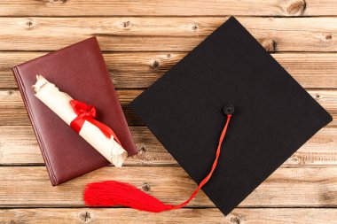 Mezuniyet Diploması ve kahverengi ahşap masa kitap kapaklı