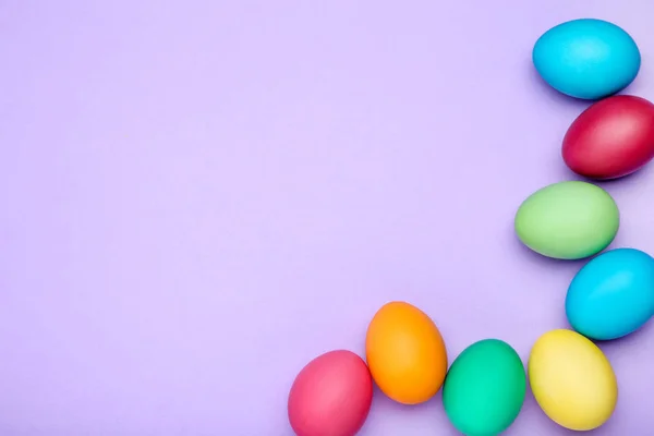 Ovos de páscoa coloridos no fundo roxo — Fotografia de Stock