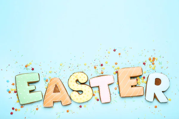 Word Easter by gingerbread cookies on blue background — Stock Photo, Image