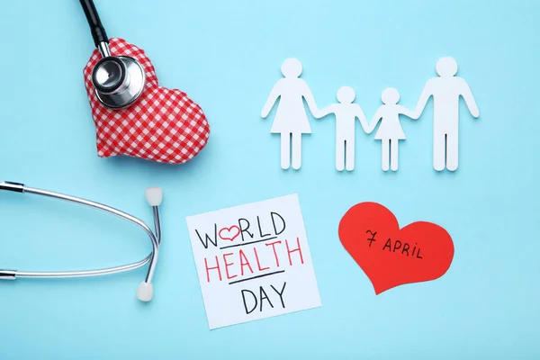 Testo Giornata Mondiale della Salute con stetoscopio e figura familiare sul blu — Foto Stock