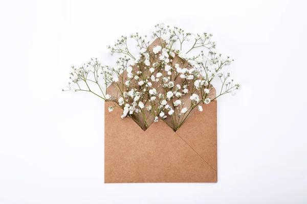 Gypsophila flowers with envelope on white background — Stock Photo, Image