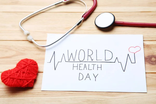 Texto Dia Mundial Saúde Com Estetoscópio Coração Vermelho Mesa Madeira — Fotografia de Stock