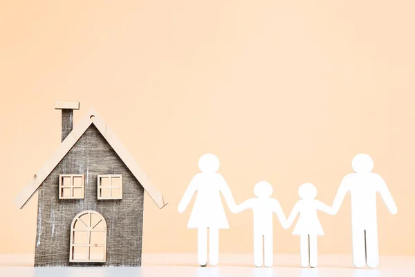 Wooden House Model Family Figure Beige Background — Stock Photo, Image