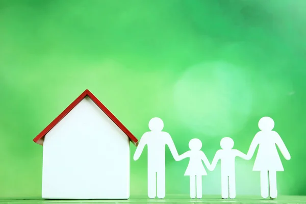 Wooden House Model Family Figure Green Background — Stock Photo, Image