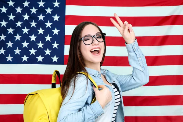 Young student with backpack on American flag background — Stock Photo, Image