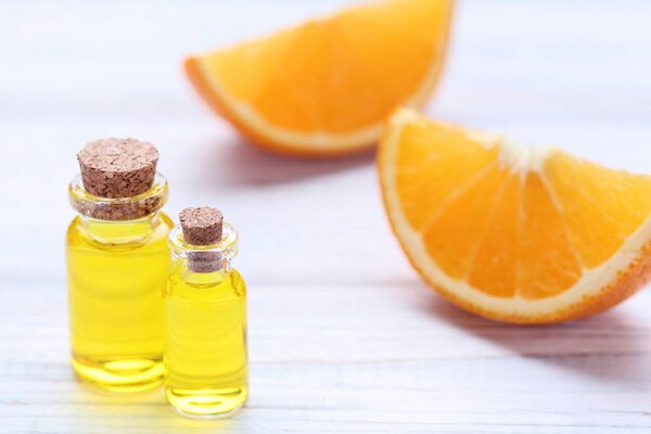 Orange oil in bottles on wooden table