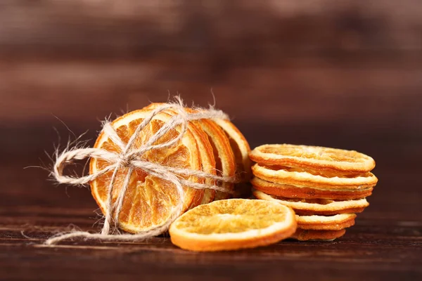 Dried orange fruits on brown wooden table — Stock Photo, Image