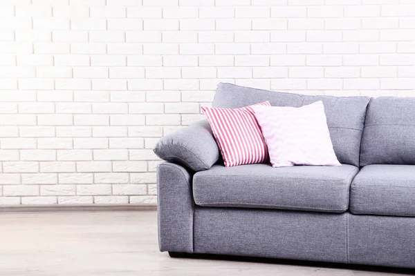 Colorful soft pillows on grey sofa — Stock Photo, Image