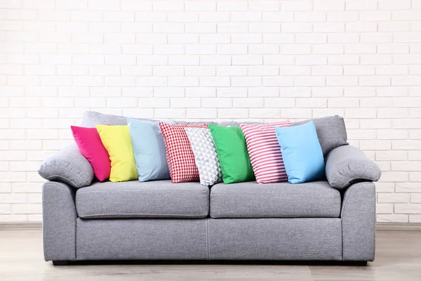 Colorful soft pillows on grey sofa — Stock Photo, Image
