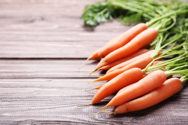 Fresh and sweet carrot on wooden background — Stock Photo, Image