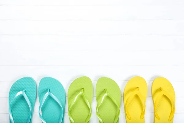 Pairs Colorful Flip Flops White Wooden Table — Stock Photo, Image