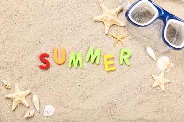 Yaz mevsimi deniz kabukları ve kumsalda dalış maskesiyle