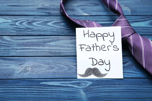 Text Happy Fathers Day with necktie on blue wooden table — Stock Photo, Image