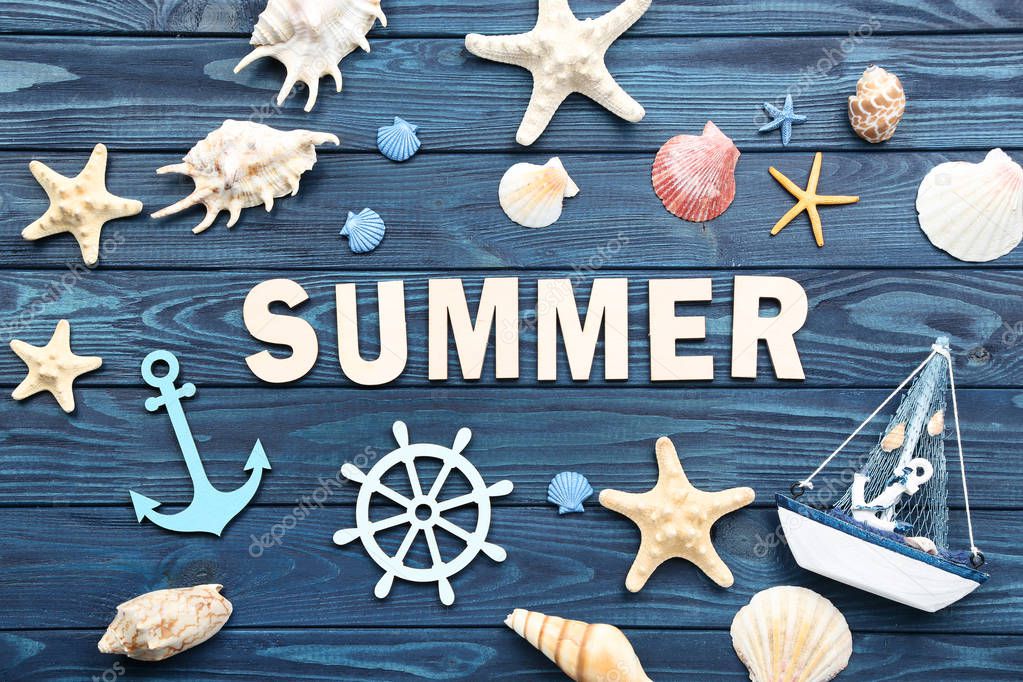Word Summer with seashells and decorative ship on blue wooden ta