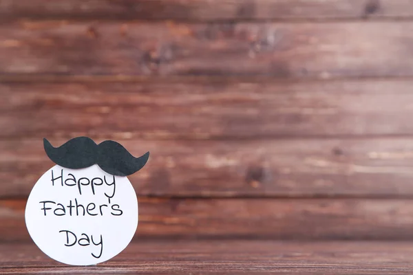 Text Happy Fathers Day with black mustache on wooden table — Stock Photo, Image