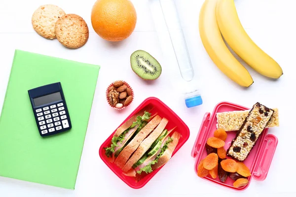 School lunch box with sandwich and fruits on wooden table — Stock Photo, Image