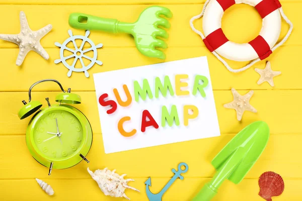 Text Summer camp with on seashells, toys and alarm clock yellow — Stock Photo, Image