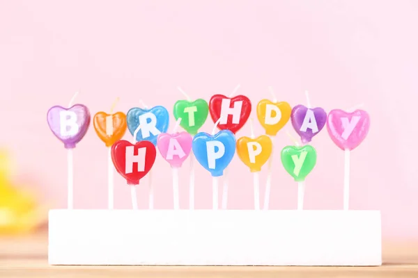Feliz cumpleaños velas sobre fondo rosa —  Fotos de Stock