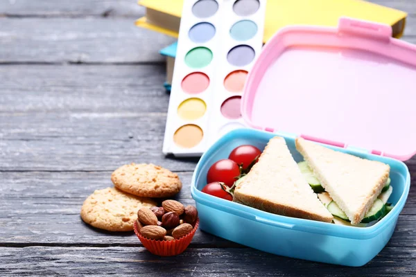 School lunch box with sandwich and cookies on wooden table — Stock Photo, Image