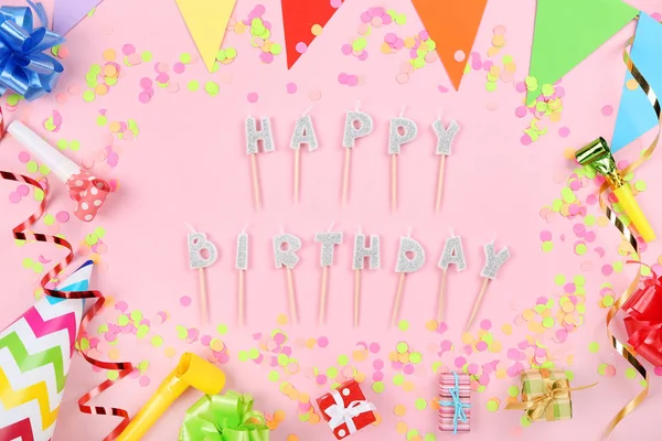Happy Birthday candles with party decorations on pink background — Stock Photo, Image