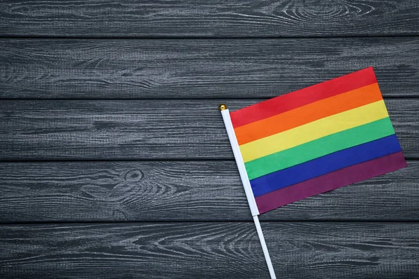 Rainbow flag on wooden table — Stock Photo, Image